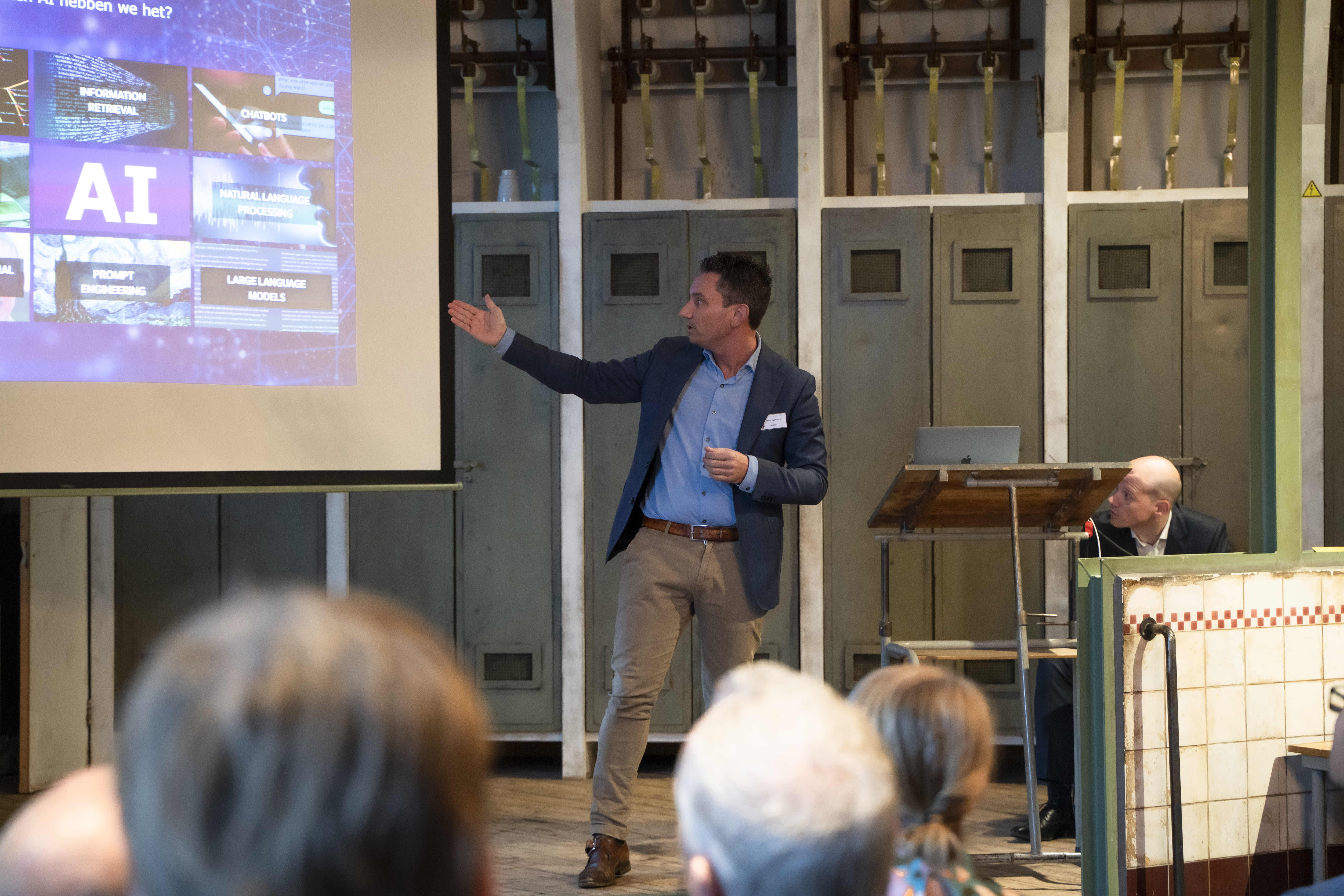 Appalti-collega’s werken samen aan de laptop, met de Appalti-canvassen aan de wand